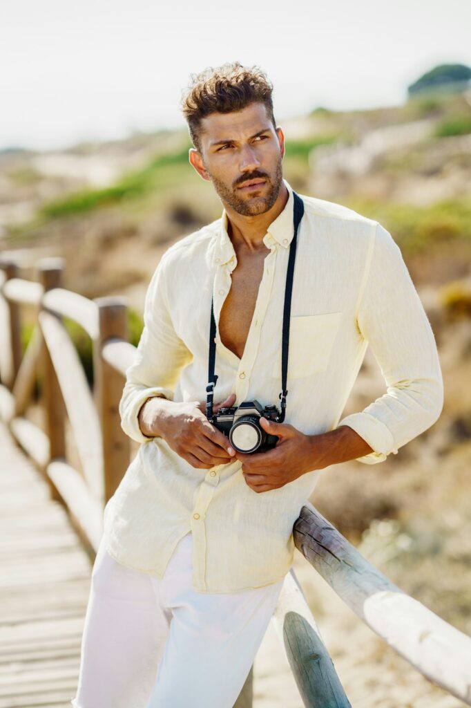 Handsome man photographing in a coastal area.